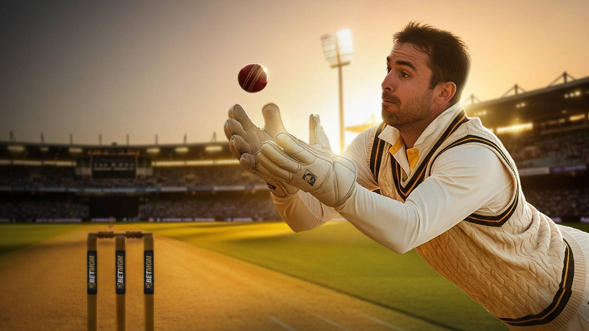 Wicketkeeper falling to catch cricket ball