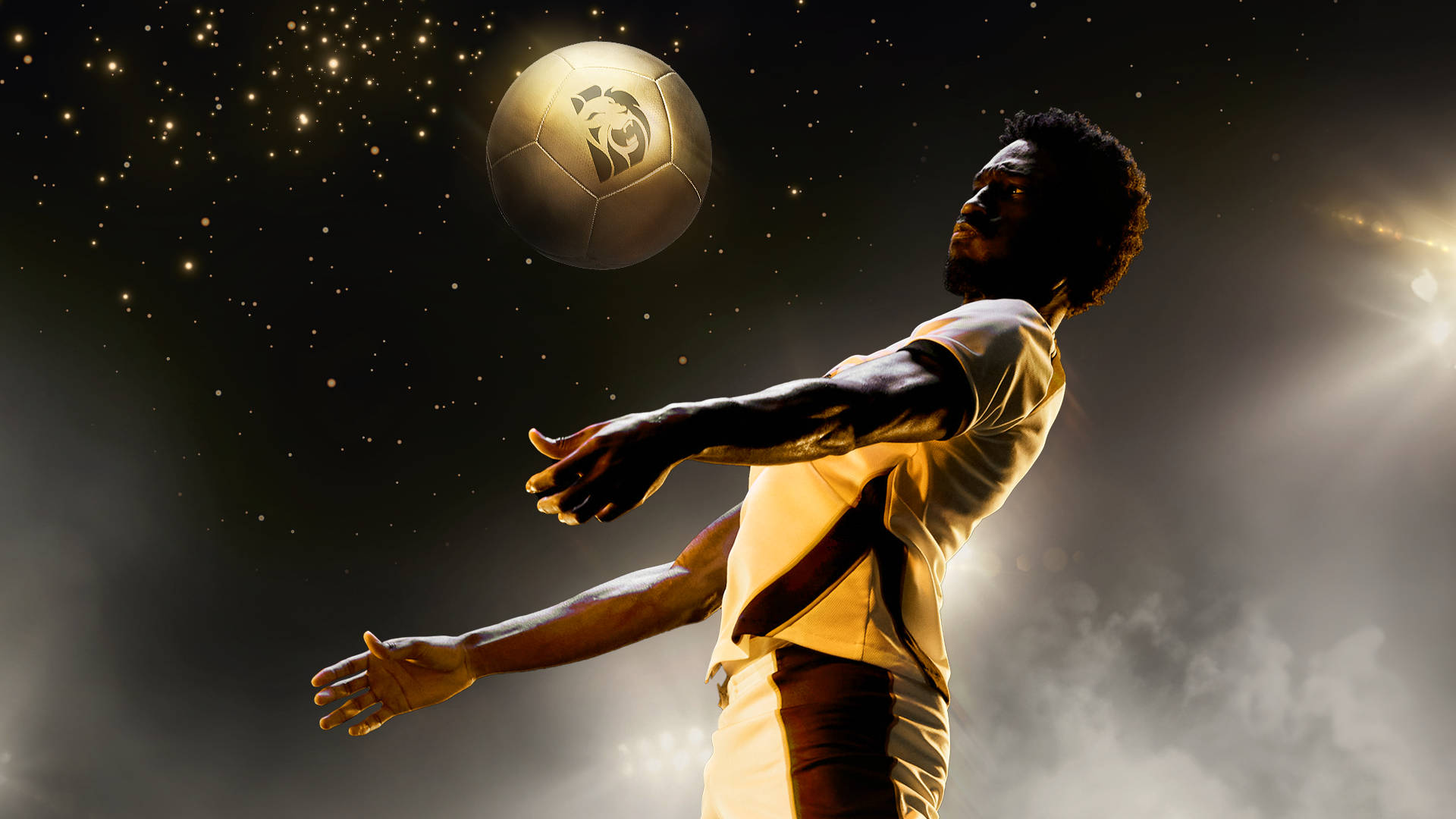 Player chesting down gold football