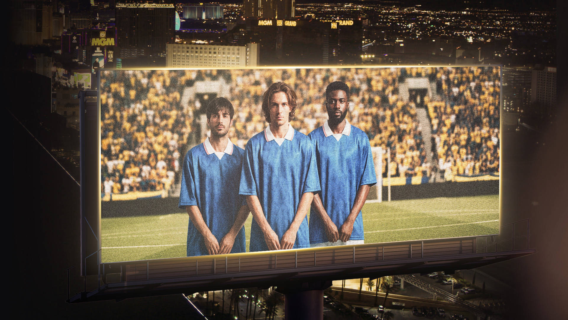 Three players in blue shirts on a big screen