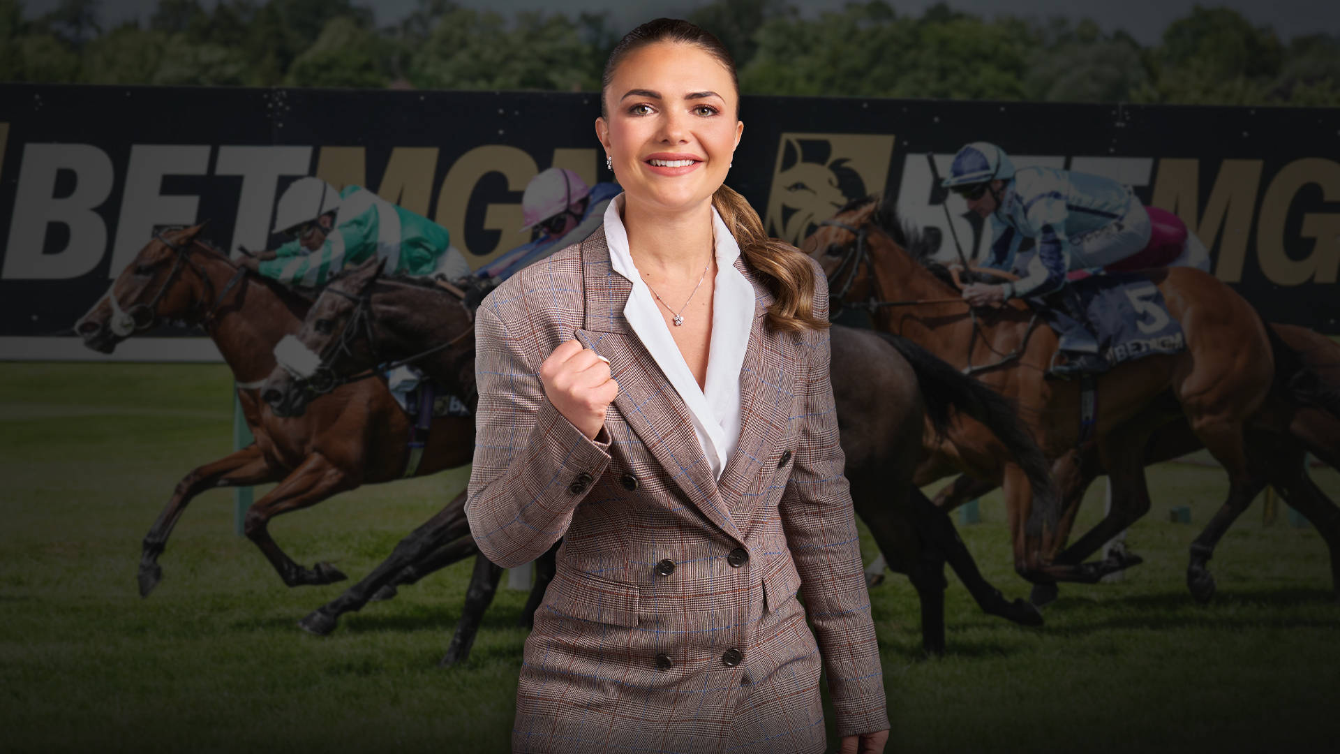 Woman in suit holding a golden jockey helmet, with horse racing in the background.